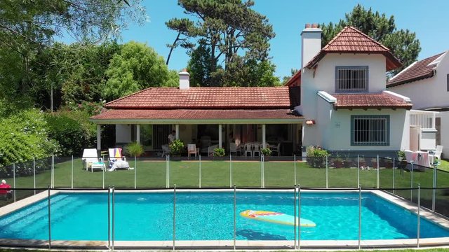 Exterior of suburban home with pool and lawn2