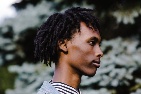 Side view of young man standing outdoors