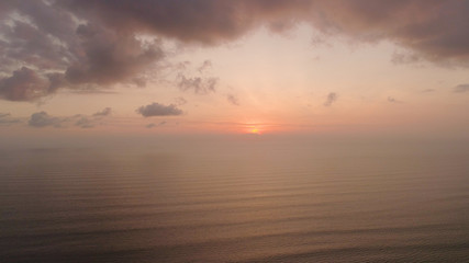 aerial view sunset over ocean. seascape. colorful sunset over sea in tropics. Flying over surface sea at sunset. aerial seascape ocean surface. Travel concept