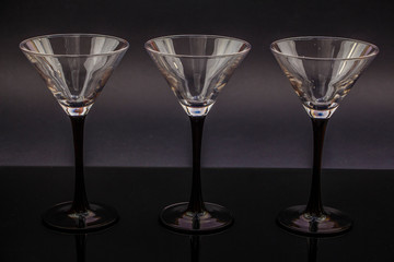 Empty martini glass, martini glasses on a black background.