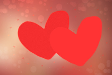 Red Happy holiday background. A couple of loving big red hearts on a red bokeh background. Space for your design.