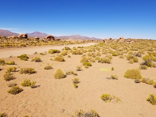 Desert road with mountains in the distance. Rocky mountains