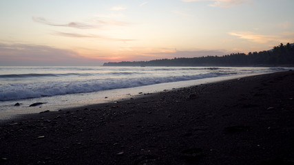 coastline with surf during sunset. sea sunset landscape on beach. Travel concept.