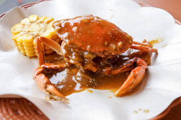 Fried crab with Padang chili sauce with boiled corn