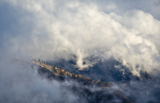 A ridge line peaks through a break in the clouds, Angeles National Forest, CA.