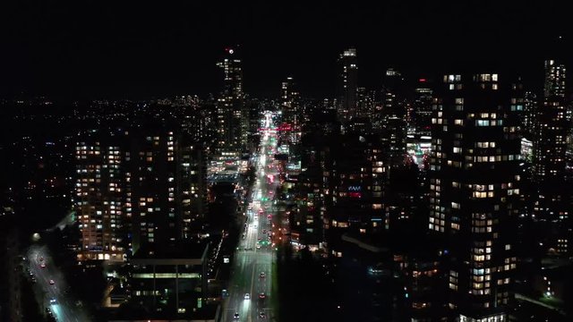 Cityscape Night. Aerial Flight. Evening illumination. 4K