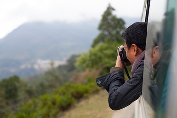 Tourist taking pictures from car