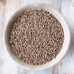 Wooden Bowl of Whole Coriander Seeds