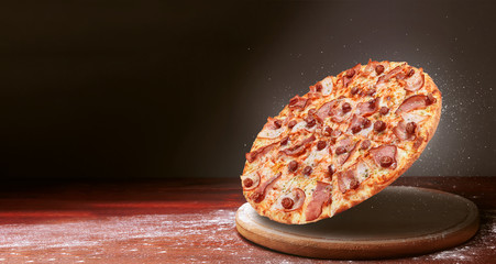 classic pizza on a dark wooden table background and a scattering of flour. pizza restaurant menu concept - Powered by Adobe