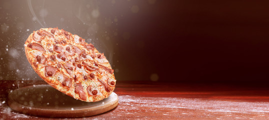 classic pizza on a dark wooden table background and a scattering of flour. pizza restaurant menu concept