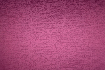 Textured background surface of textile upholstery furniture close-up. magenta red Color fabric structure