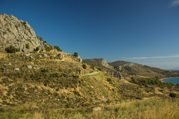 summer Savannah dry mountain rock scenery landscape with curved car road through highland space