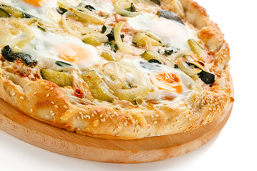 Vegetarian pizza with eggs, zucchini and onion