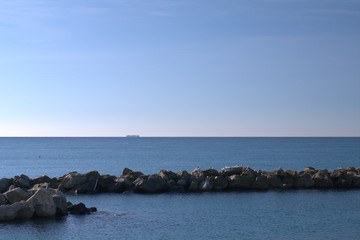 Fototapeta na wymiar sea and sky,container ship,horizon,view,blue,stone,seascape