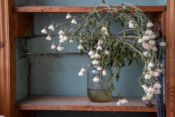 A bouquet of flowers in a jar was taken