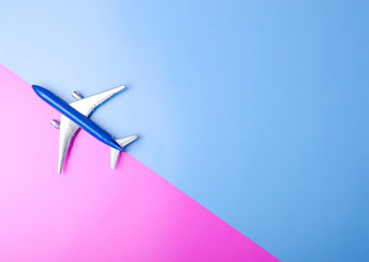 Naklejka premium Blue model plane,airplane on color pink blue background, top view