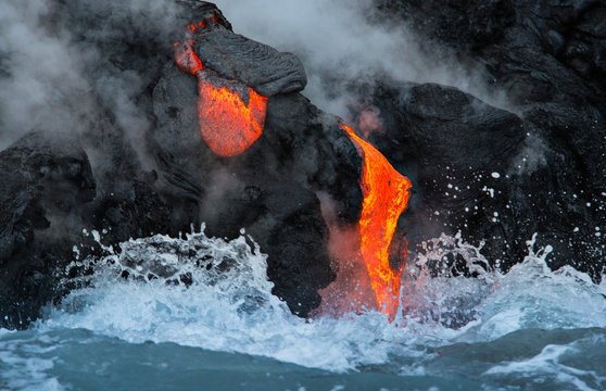 Lava enters the ocean from  Kilauea's Puu oo vent near Kalapana in Hawaii Volcanoes National Park.