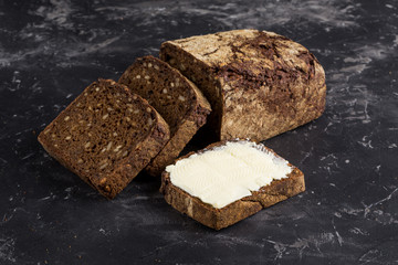 Rye bread on dark board background