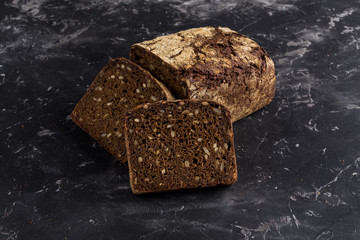 Rye bread on dark board background