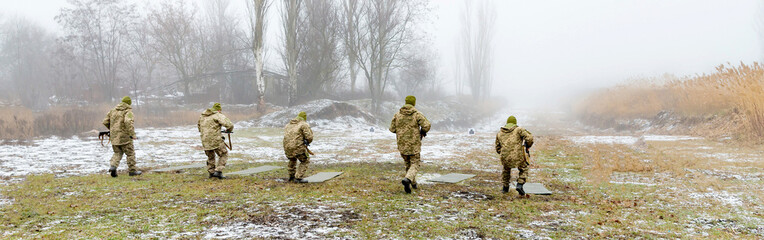 Soldiers in the shooting training at the site preparing for shooting, panoramic photos.