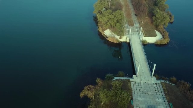 Aerial footage over Echo Park Lake, Kishinev, Moldova republic of. View of lake and smille bridge.