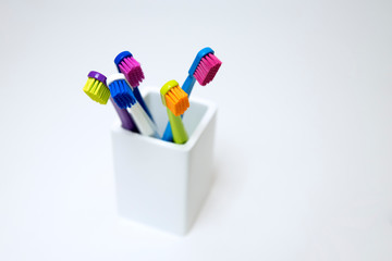 Colorful toothbrushes on a light background