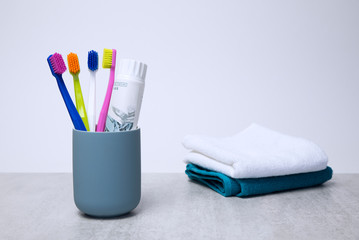 Colorful toothbrushes on a light background - obrazy, fototapety, plakaty