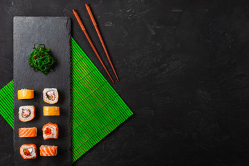 Set of sushi and maki on stone table. Top view with copy space