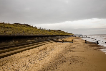 Walking along the beach in an overcast autumn day