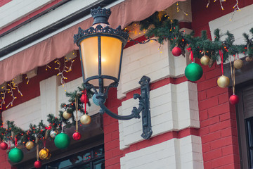 Christmas decorations and retro lantern on the city street