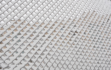 abstract pattern of snowy chain-link fence