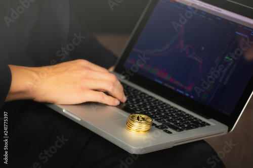Businessman Working On Laptop With A Golden Bitcoin Coins - 