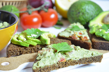 Guacamole and bread. Toast with avocado on white background. Homemade Mexican healthy vegan food