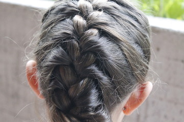 Portrait of hairstyle with braid of young girl