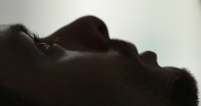 Closeup of male face and eye wake up in bed at the morning