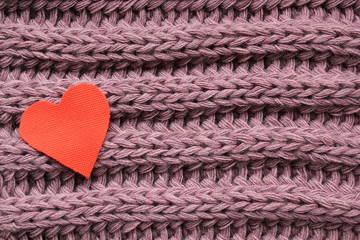 Textile heart on a violet knitted background