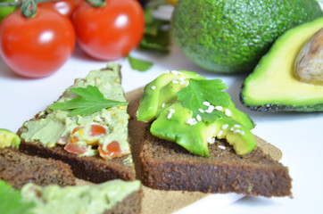 Guacamole and bread. Toast with avocado on white background. Homemade Mexican healthy vegan food