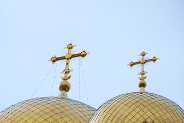 Fototapeta na wymiar Two domes of the old russian church with the cross