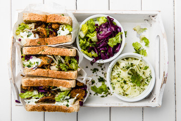 delicious gyros sandwich in paper bag with salad and tzatziki
