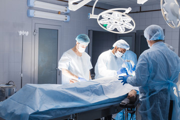 Team of Professional surgeon, assistants prepare a patient to invasive surgery in the Hospital...