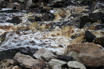 the river flows through a rocky pass, the water of a stream