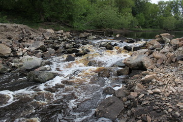 the river flows through a rocky pass, the water of a stream