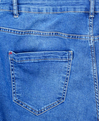 fragment of blue jeans with back pocket