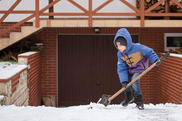 Little boy ploughs the drive
