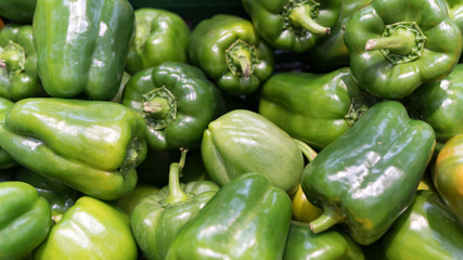 Fototapeta na wymiar Green fresh bell pepper or capsicum in the market used for your pattern or your background design. Food and healthy care concept