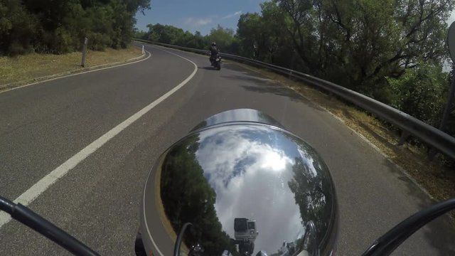 Motorcycle ride on a winding road in Sardinia, Italy