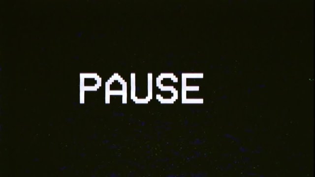 A capture of a VCR playing and pausing a VHS blank tape: the big text Pause, appearing with a blinking symbol, at the center of the screen. Digital remake.