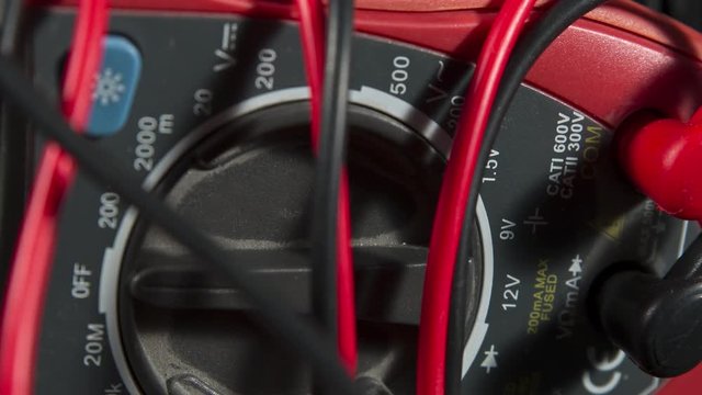 Close-up of digital multimeter, electronic measuring instrument. Multitester device electric tool for measurement of voltage, electric current, resistance and others. 4k ProRes HQ codec