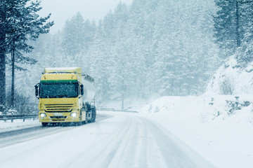 Traffic truck on winter road in snow blizzard - 241788592