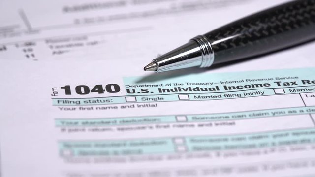Slow rotate with dolly around the title of the 2018 simplified form 1040 for US tax returns due on April 15, 2019